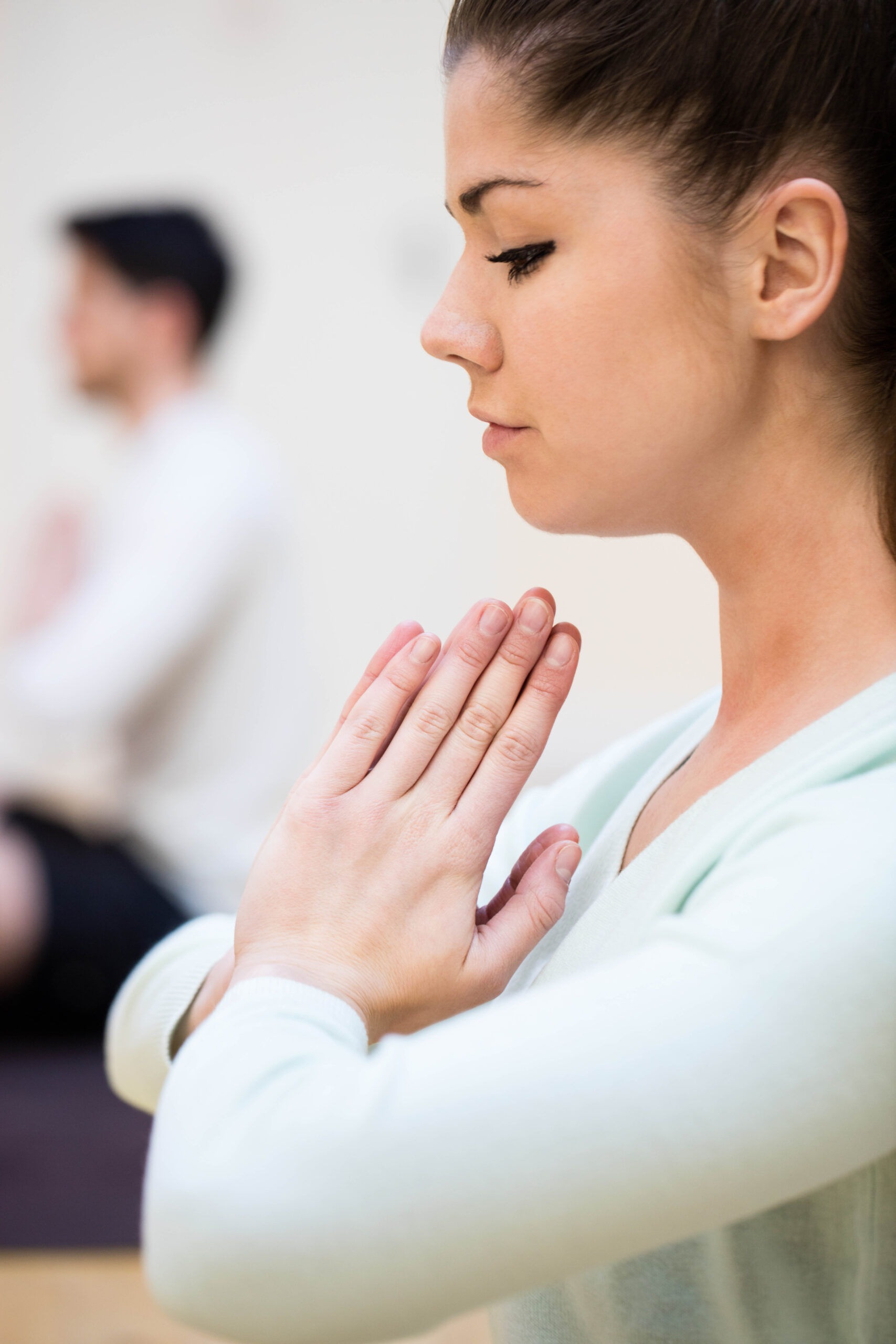 close up of beautiful woman sitting in lotus position